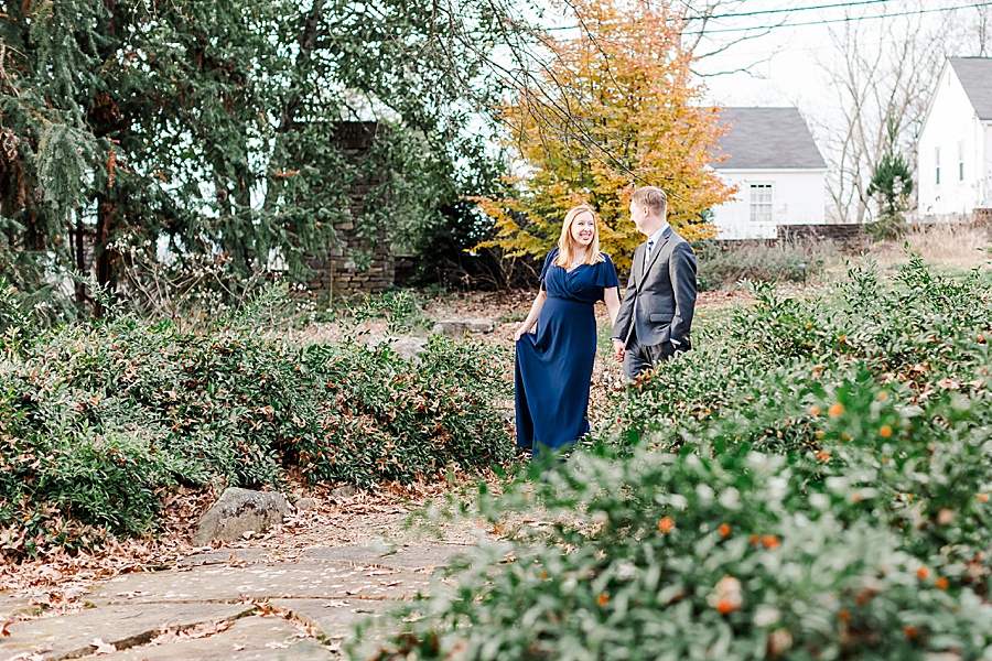couple walking holding hands with fall color in december