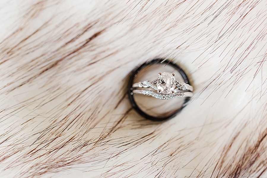 wedding rings detail shot on fur wrap black wedding band