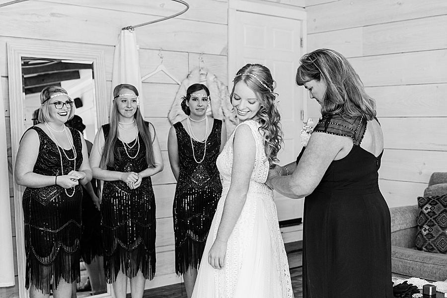 bride getting ready with mom's help black and white
