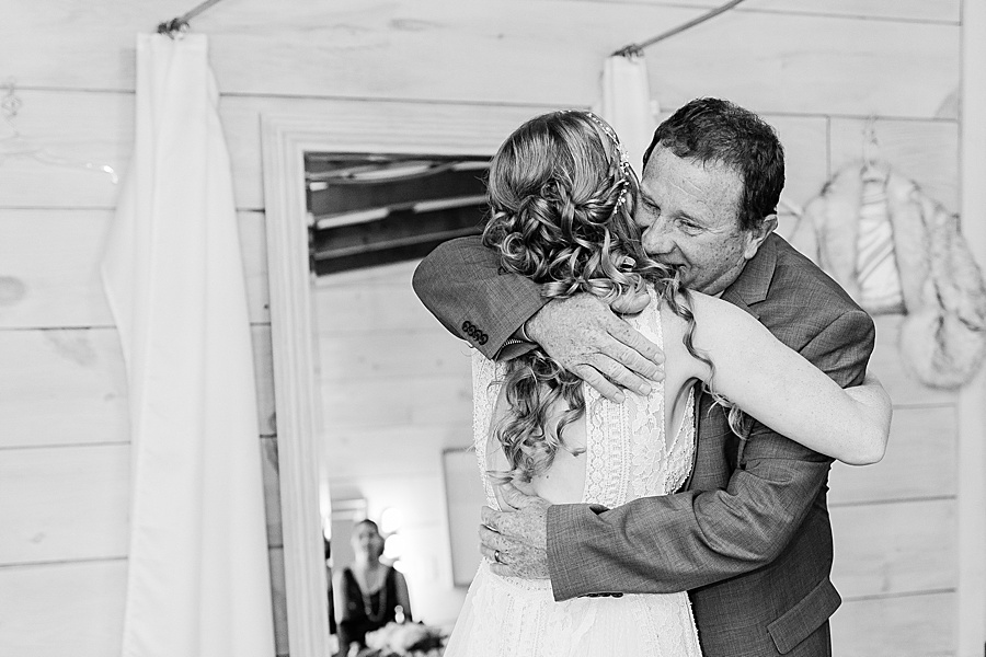 bride and dad embrace