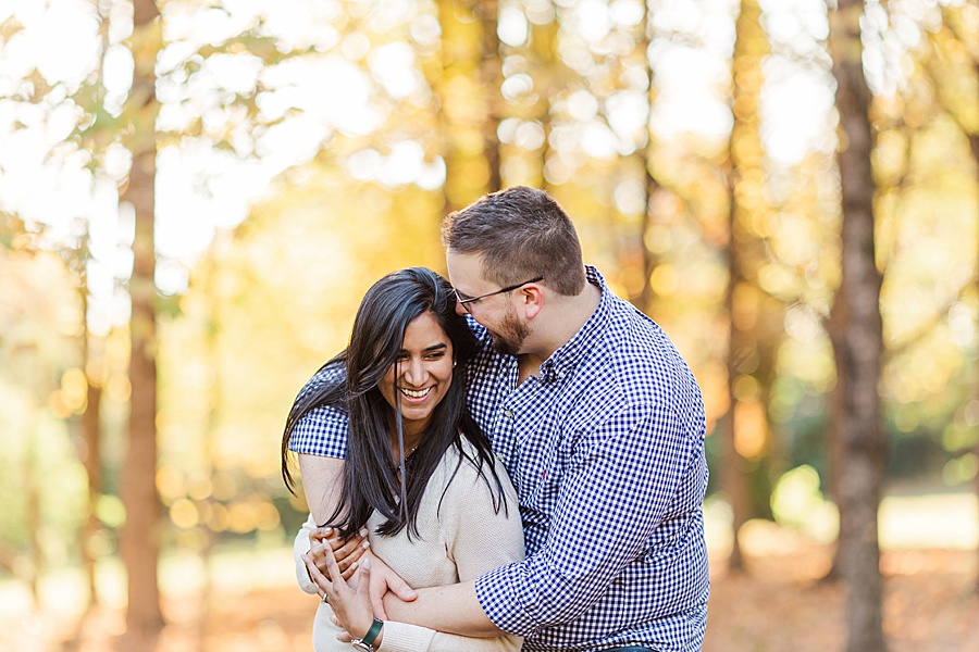 couple in fall leave hugging