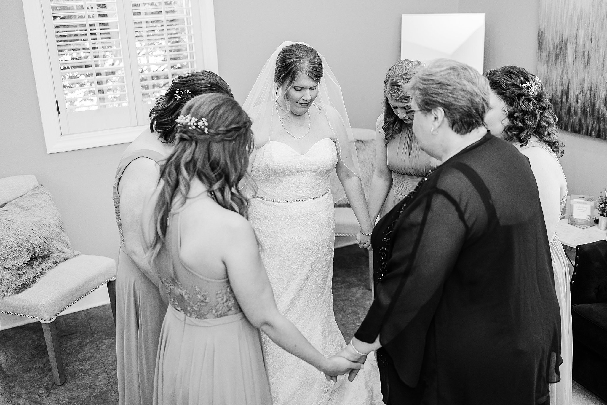 bride and bridesmaids praying before ceremony