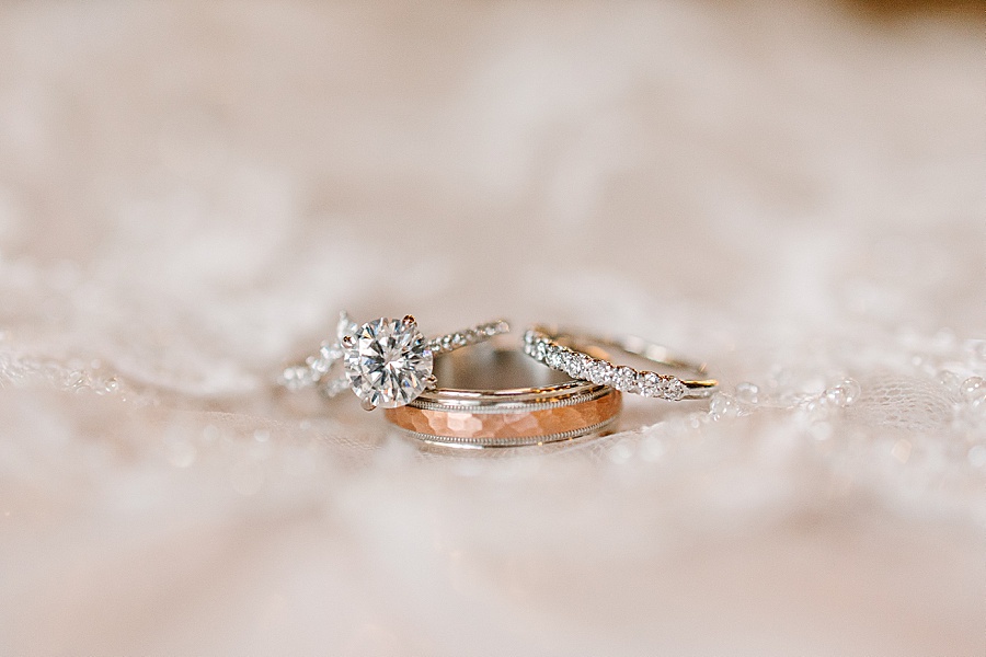 Set of wedding rings in white gold and rose gold on lace Jackson Terminal in Knoxville TN by Mandy Hart Photo, Knoxville TN Wedding Photographer
