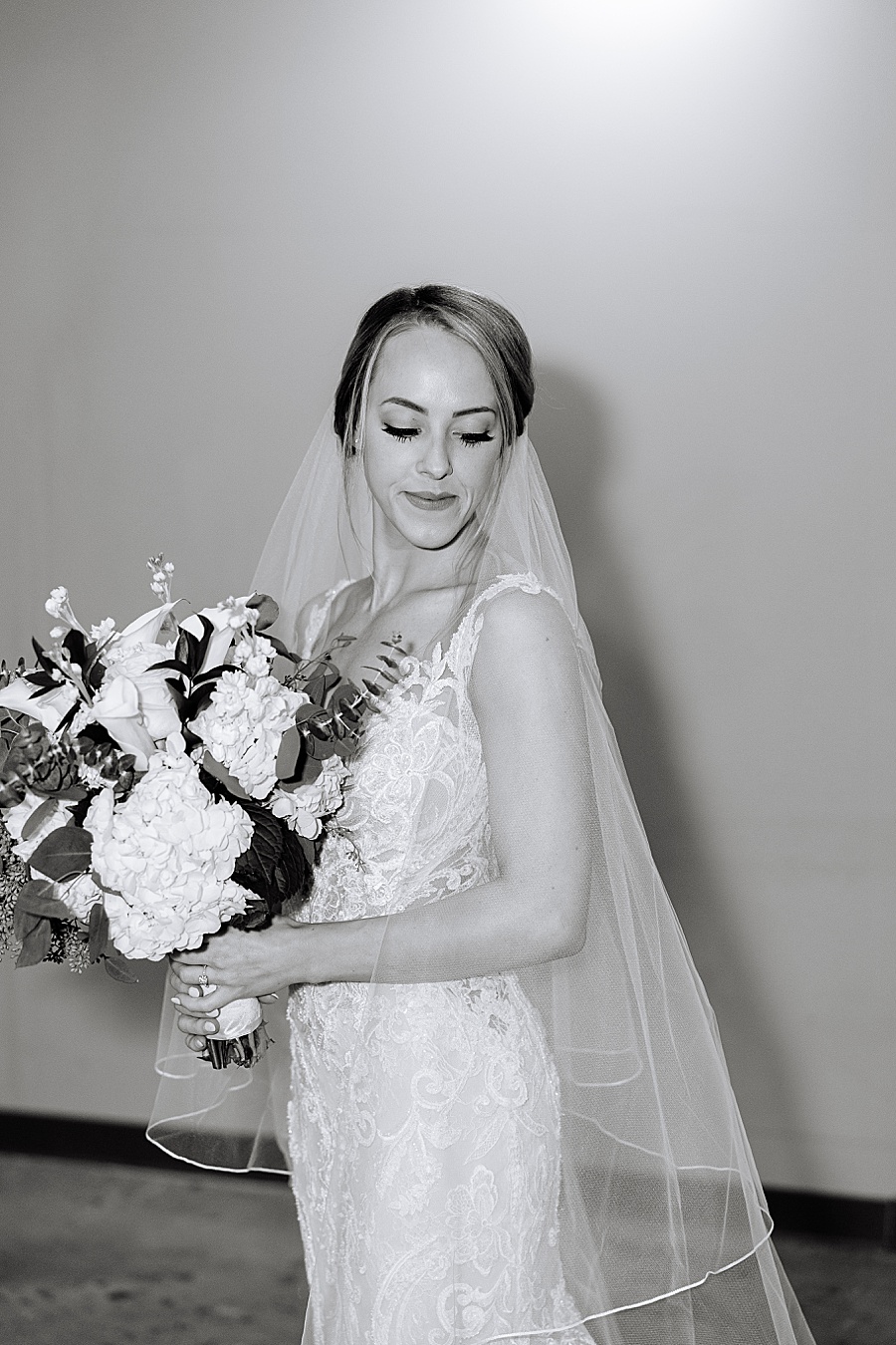 Bride with lace dress and veil and bouquet getting ready at Jackson Terminal in Knoxville TN by Mandy Hart Photo, Knoxville TN Wedding Photographer