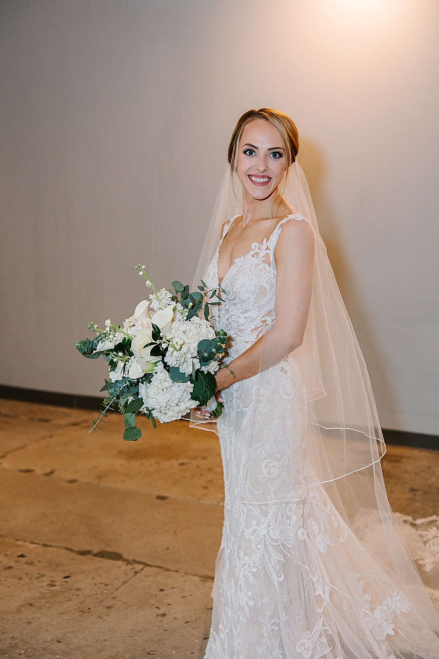 Bride with lace dress and veil and bouquet getting ready at Jackson Terminal in Knoxville TN by Mandy Hart Photo, Knoxville TN Wedding Photographer