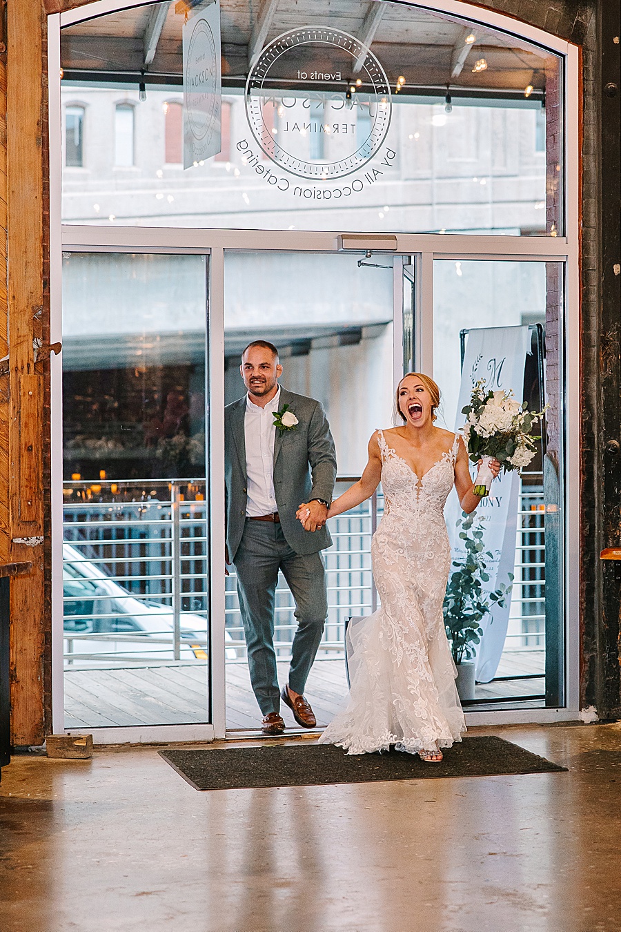 Bride and groom entering reception at Jackson Terminal events wedding in Knoxville TN by Mandy Hart Photo, Knoxville TN Wedding Photographer