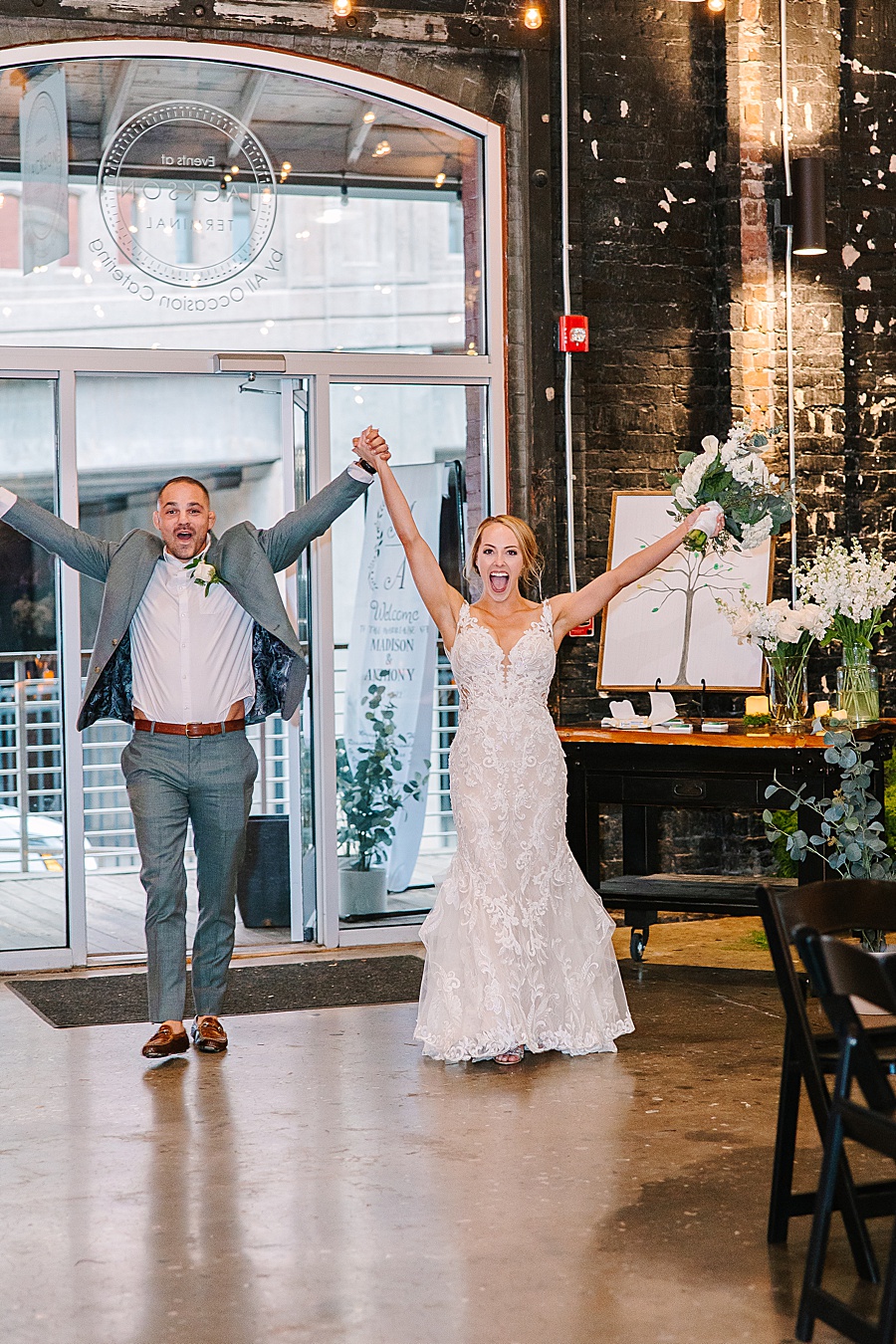Bride and groom entering reception at Jackson Terminal events wedding in Knoxville TN by Mandy Hart Photo, Knoxville TN Wedding Photographer
