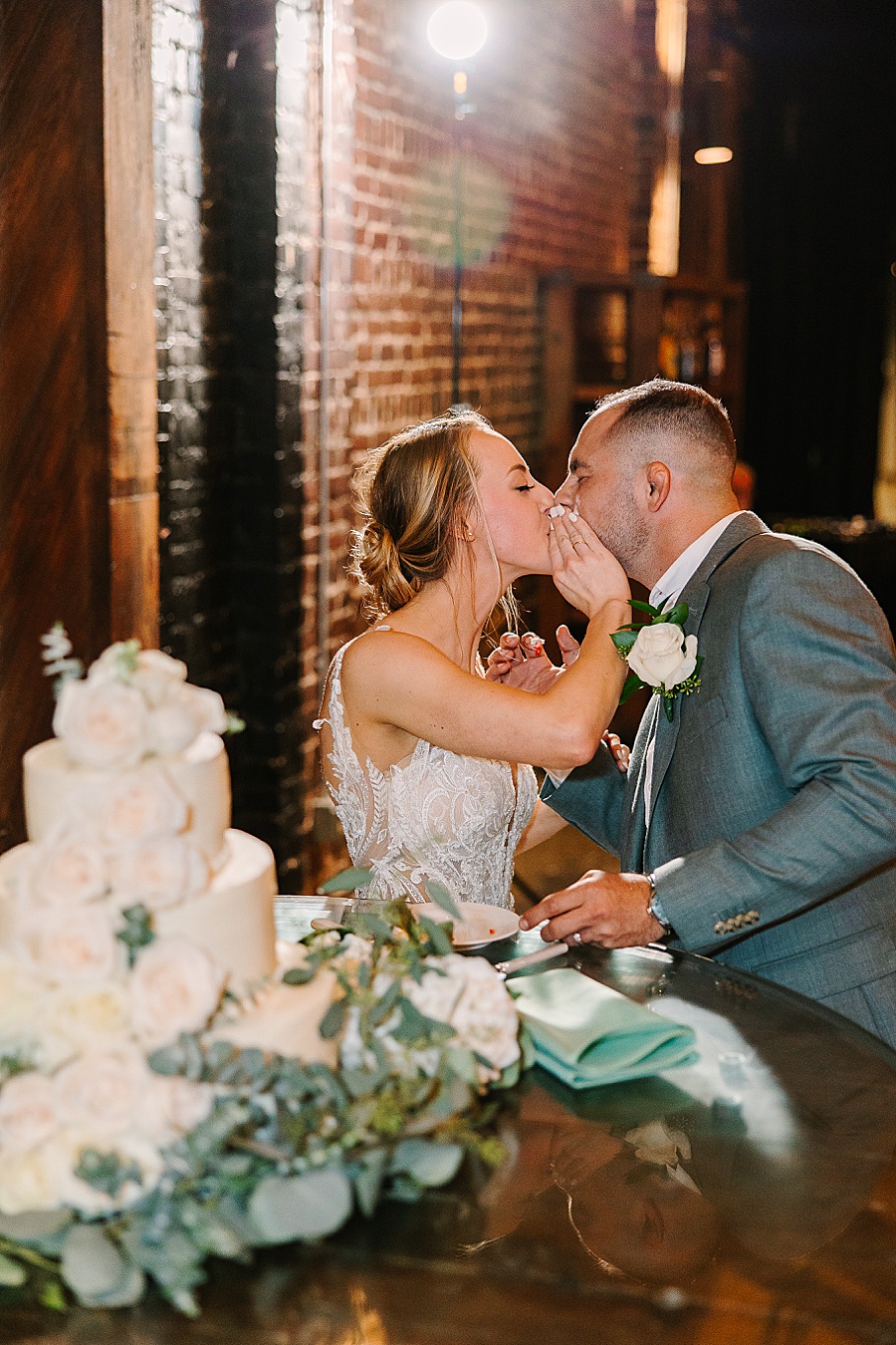 Bride & groom cutting cake at reception at Jackson Terminal events wedding in Knoxville TN by Mandy Hart Photo, Knoxville TN Wedding Photographer