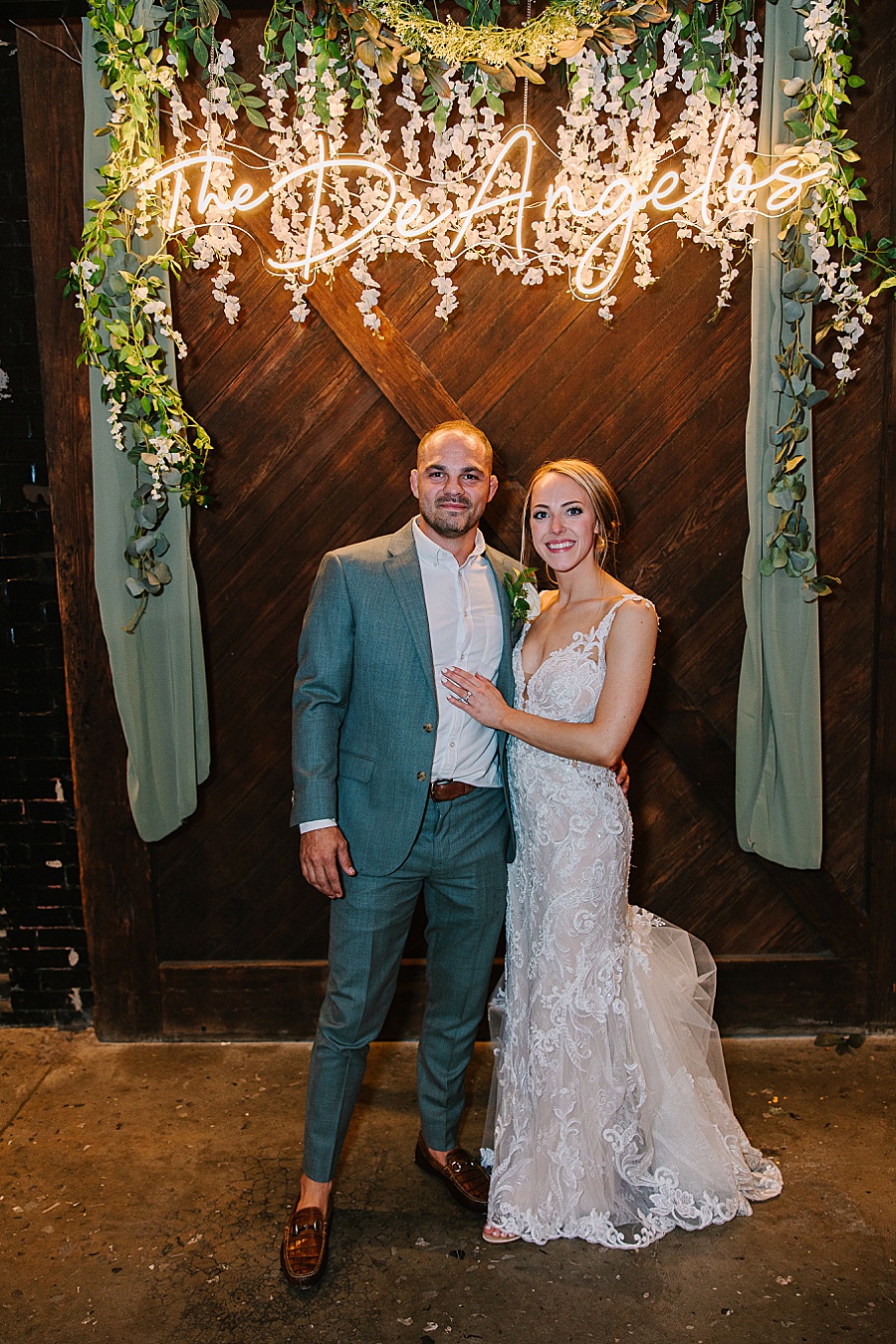 Bride & Groom with neon name sign at reception at Jackson Terminal events wedding in Knoxville TN by Mandy Hart Photo, Knoxville TN Wedding Photographer