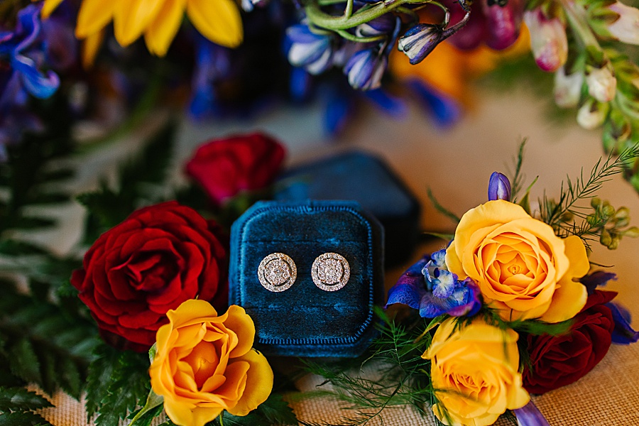 bridal earrings in blue velvet box with vibrant florals at Venue at Greenbrier Estate by Mandy Hart Photo Knoxville Wedding photographer