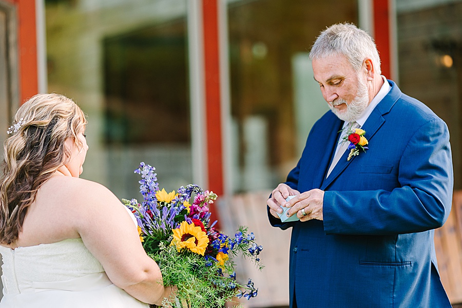 daughter giving dad gift on wedding day in blue suit at Venue at Greenbrier Estate by Mandy Hart Photo Knoxville Wedding photographer