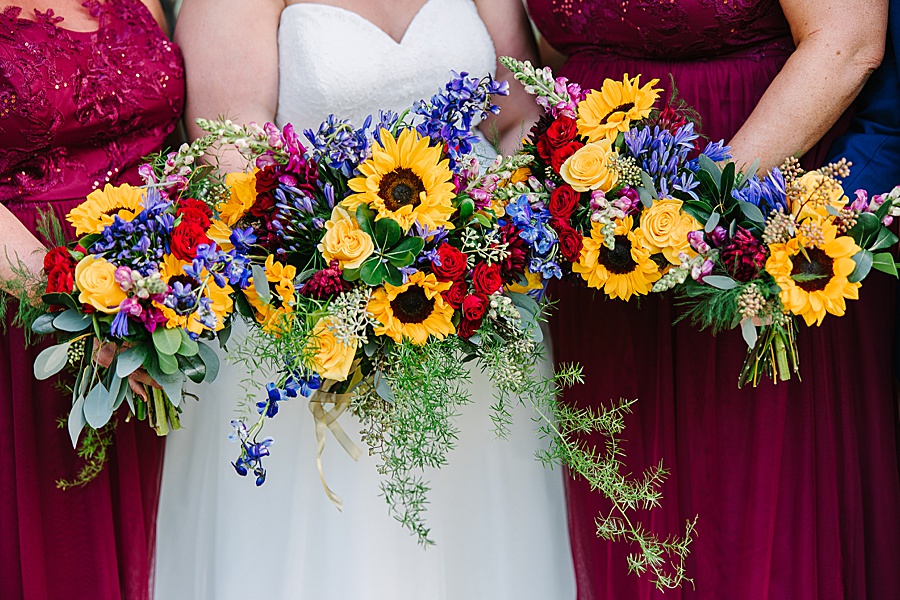vibrant floral bouquets with sunflowers and burgundy dresses at wedding at Venue at Greenbrier Estate by Mandy Hart Photo Knoxville Wedding photographer