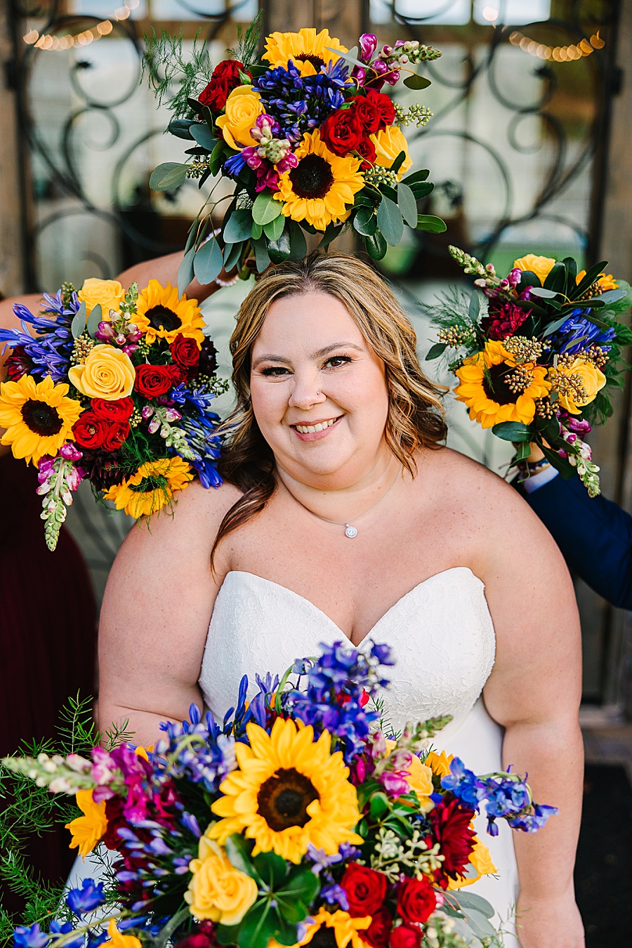 bride surrounded by vibrant floral bouquet ring at wedding at Venue at Greenbrier Estate by Mandy Hart Photo Knoxville Wedding photographer