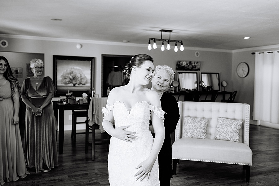Black and white image of bride getting ready with mother of bride
