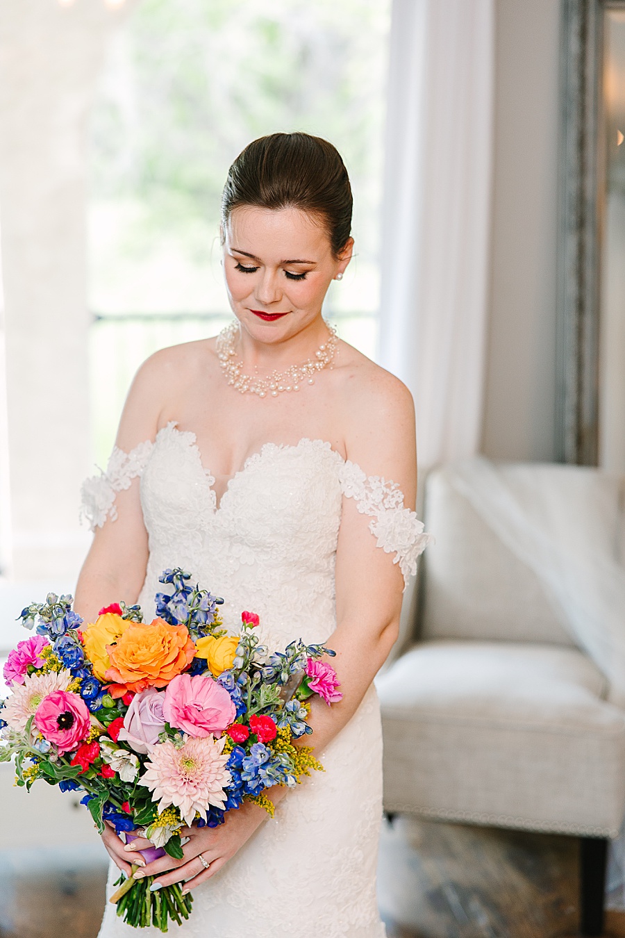bride with vibrant floral wedding bouquet