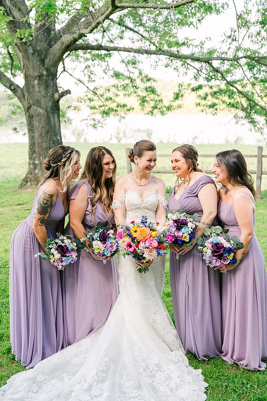 Bride and bridesmaids giggling on wedding day