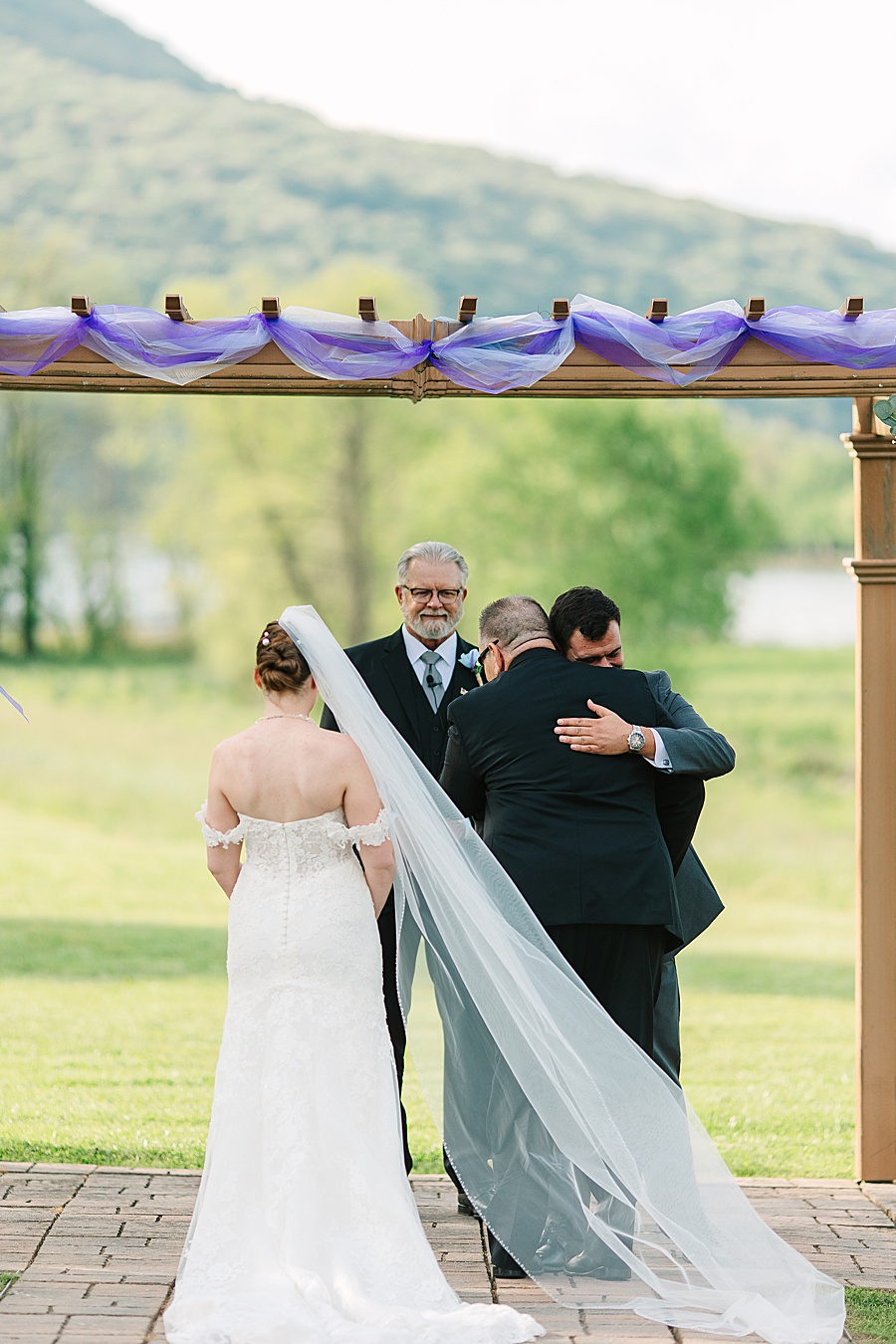 groom hugging father of bride on wedding day