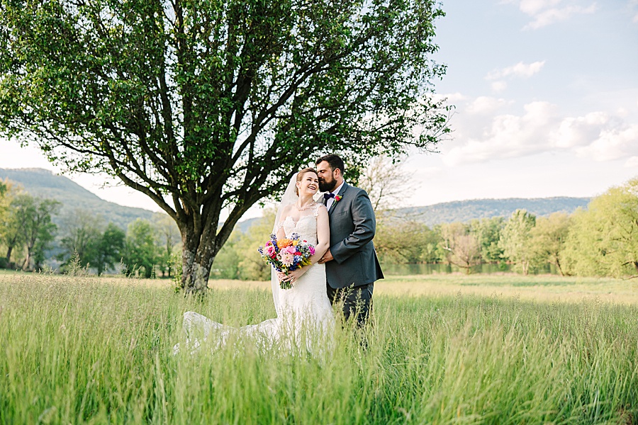 bride and groom kissing in a field of tall grass at Tennessee Riverplace