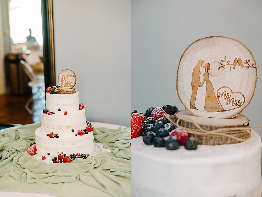 Wedding cake with berries and carved wood topper