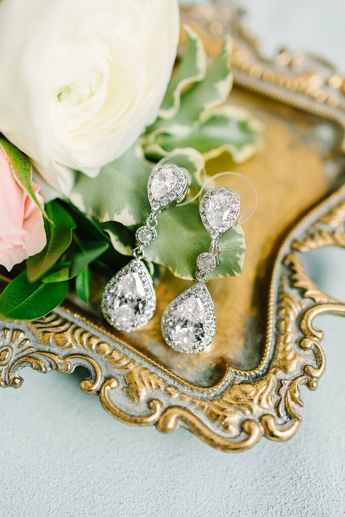 Crystal tear drop wedding earrings on gold tray