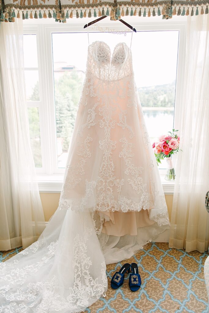 Lace wedding dress hanging in window