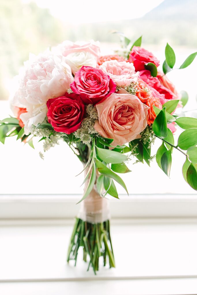 beautiful wedding bouquet in shades of pinks with roses and peonies