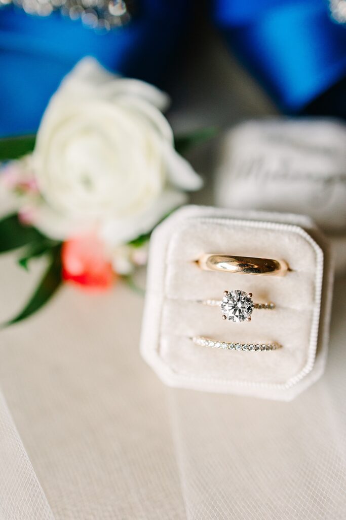 Diamond wedding ring and bands in white velvet ring box