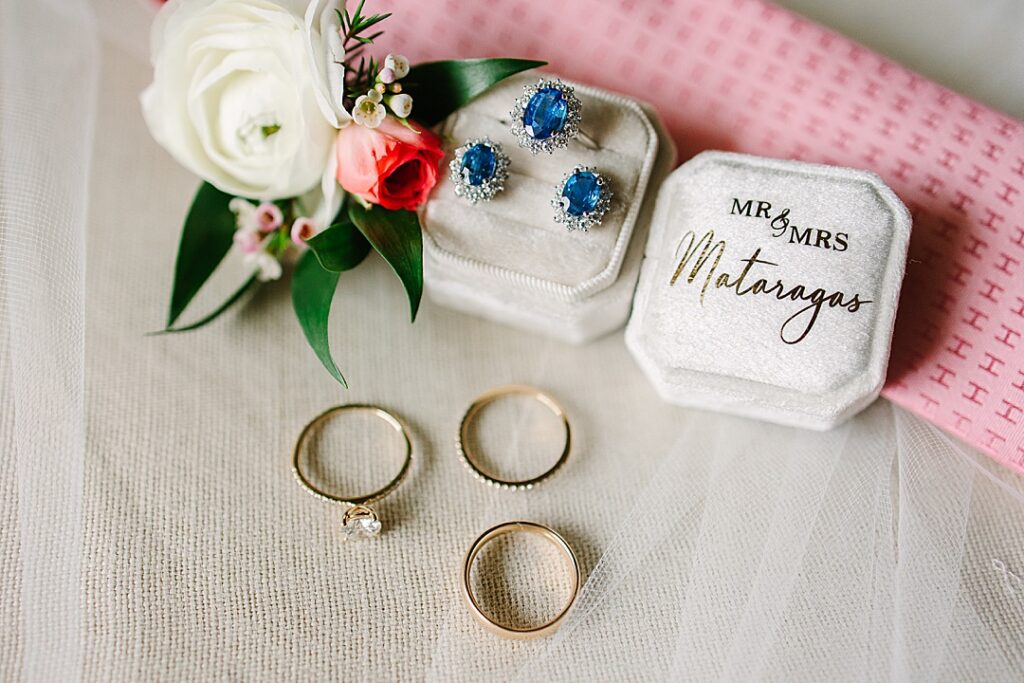 detail shot of bridal wedding jewelry in custom velvet ring box and sapphire and diamond bridal earrings and ring.