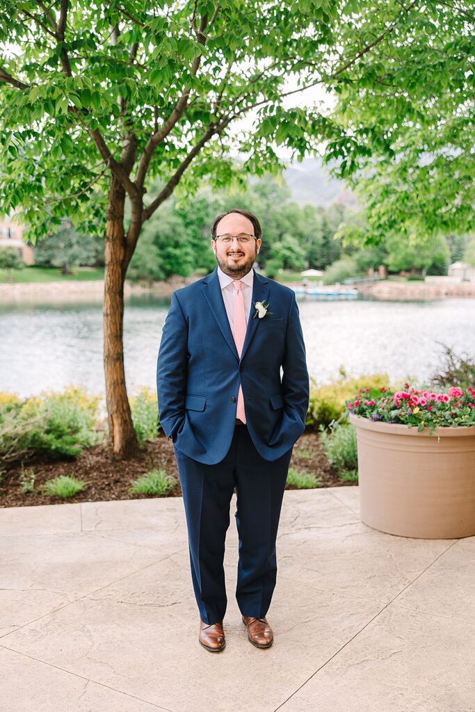 groom in navy suite on wedding day