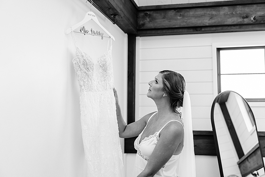 bride looking at wedding dress for fall wedding at candies creek farm