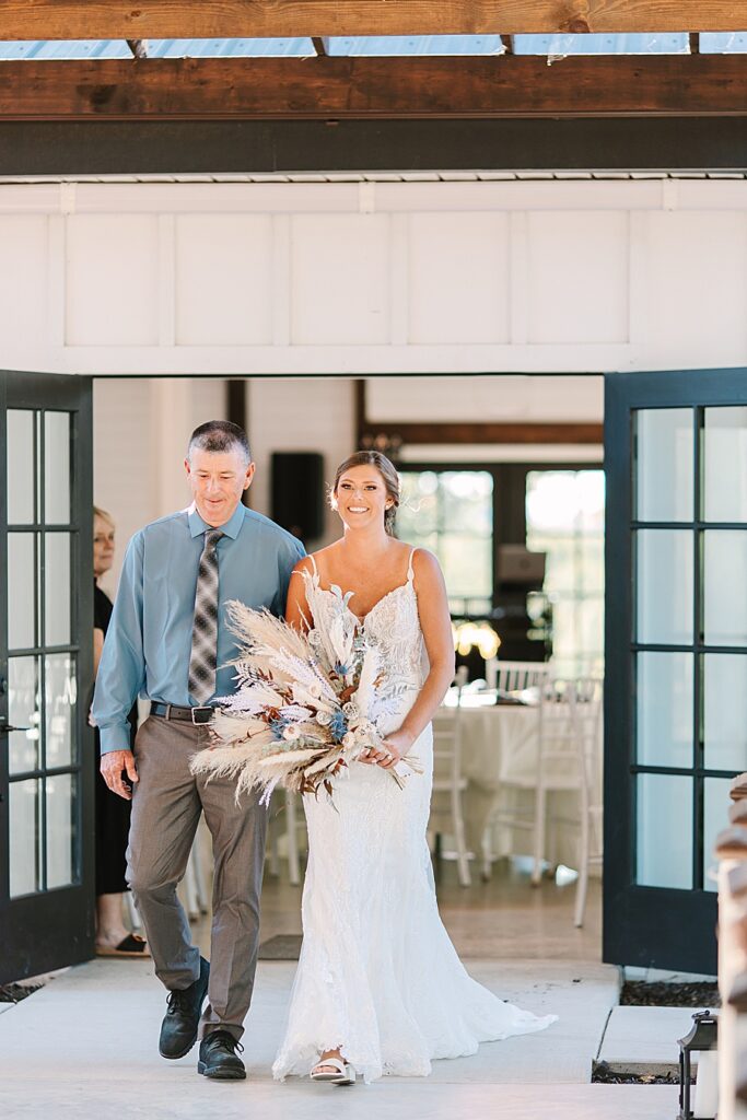 bride and dad walking down the aisle at a fall wedding at candies creek farm