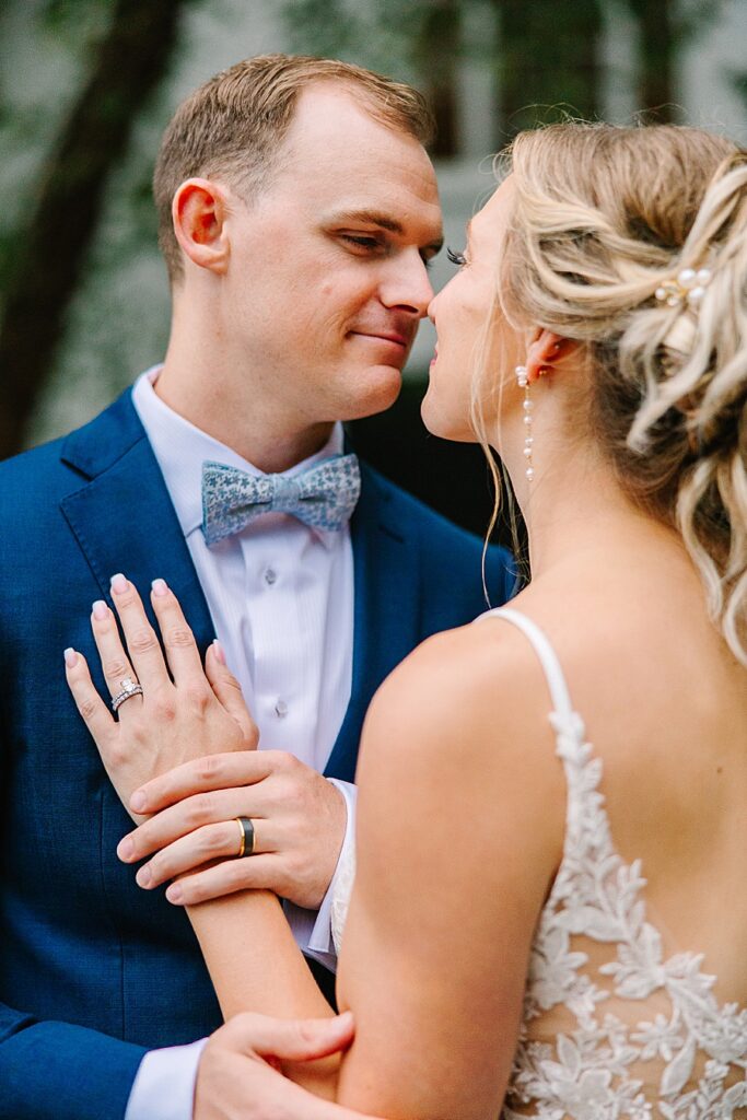 Bride and groom in embrace holding hands