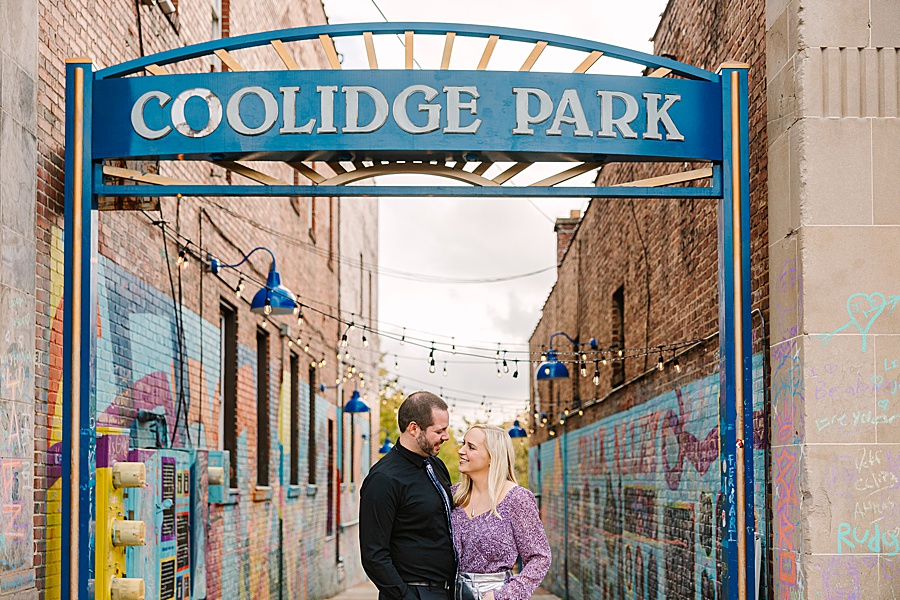 Couple embracing under the entrance sign to coolidge park