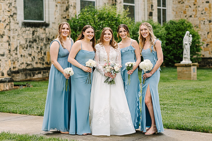 Bride with bridesmaids in pale blue dresses