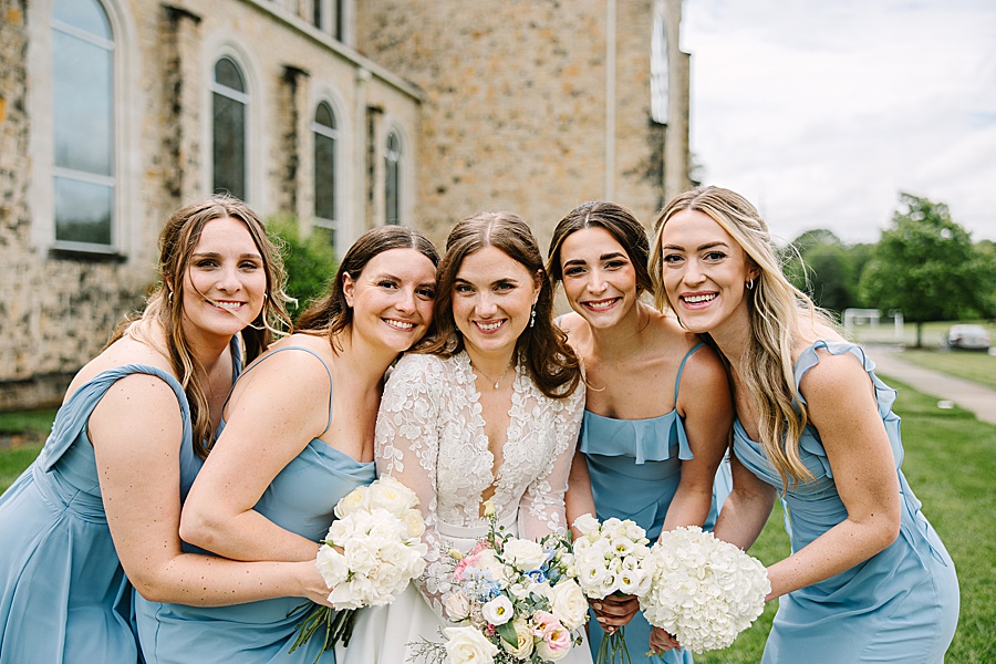 bridesmaids loving on their precious bride