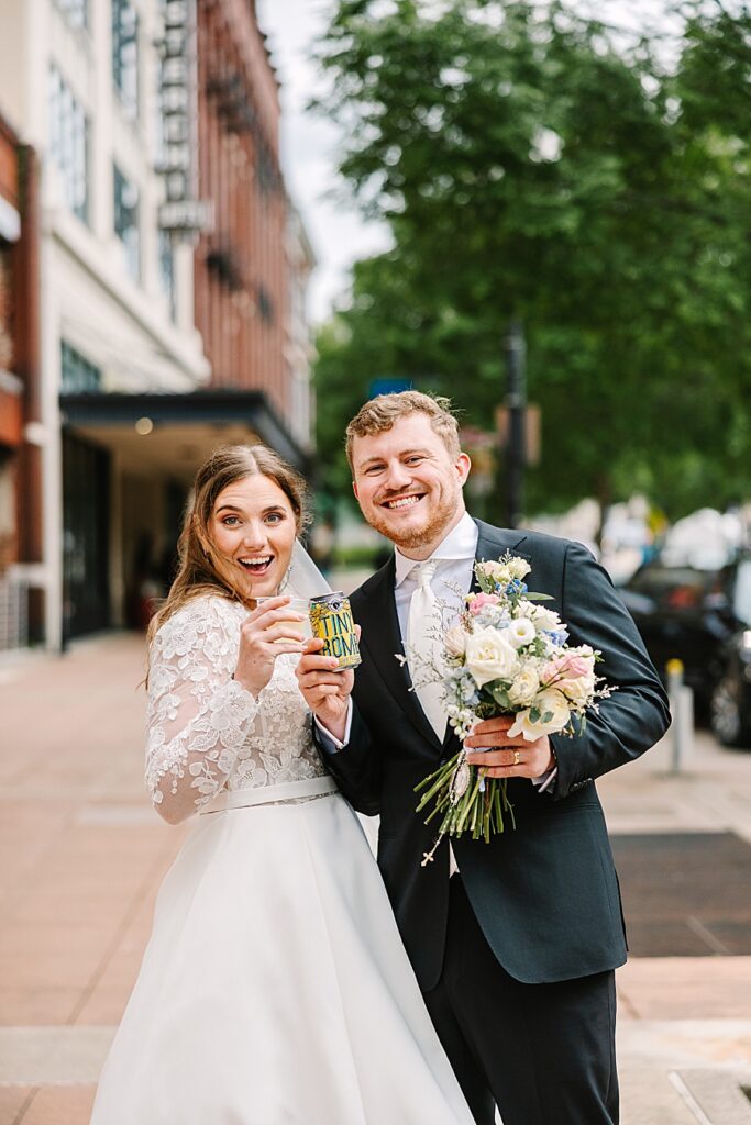 bride and groom toasting outside of reception venue