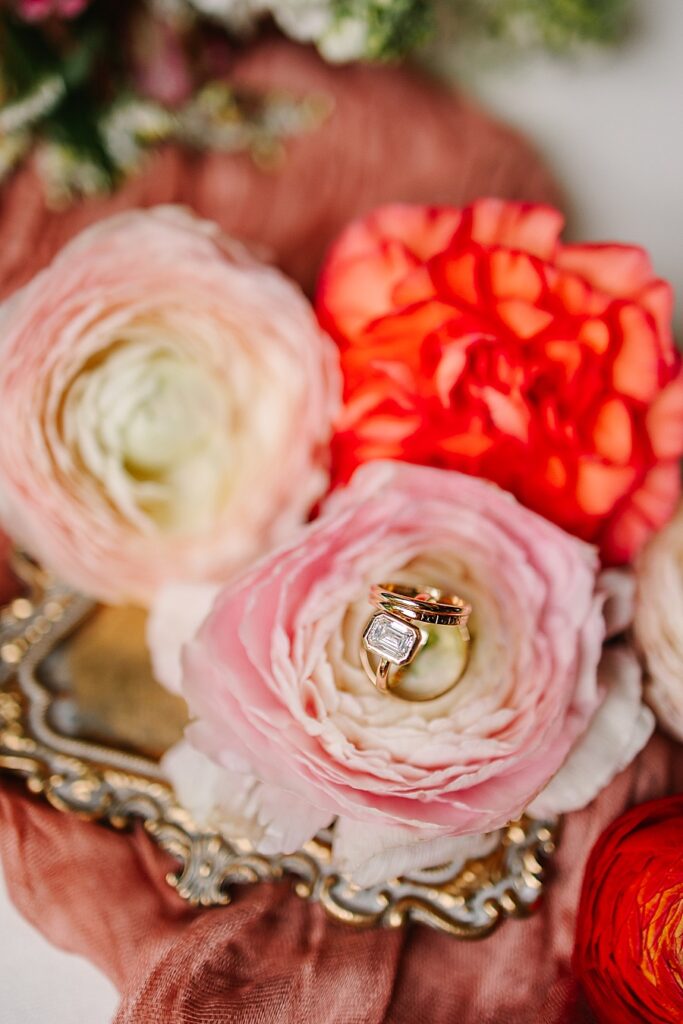 diamond engagement ring sitting atop florals at the venue at the bluffs wedding