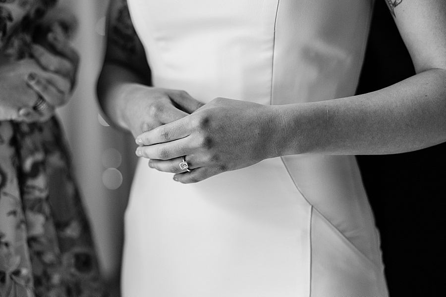 black and white detail shot of brides hand showing her engagement ring