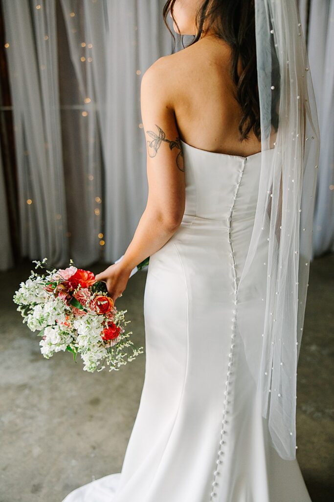 detail shot of back of brides dress showing button details