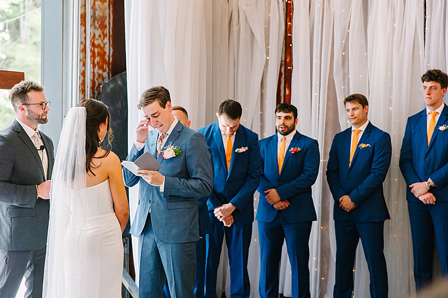 groom crying during vows at wedding at venue at the bluffs