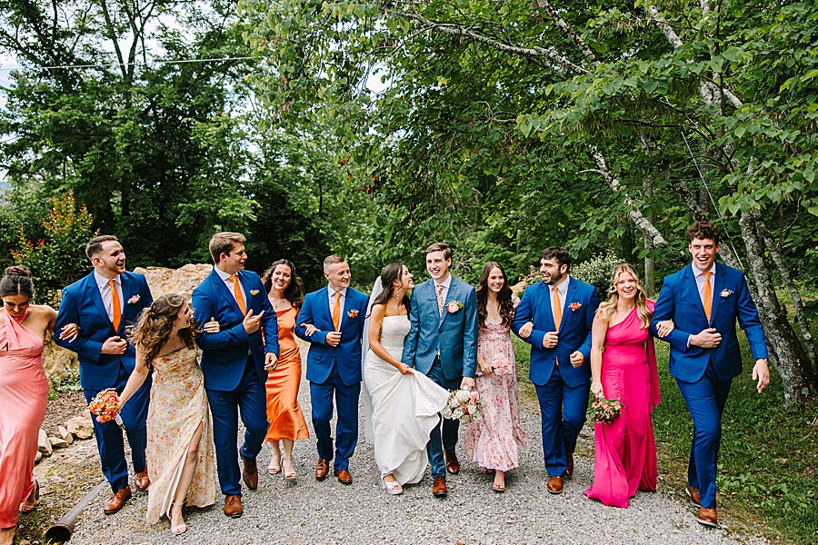 bridal party walking together after wedding at venue at the bluffs