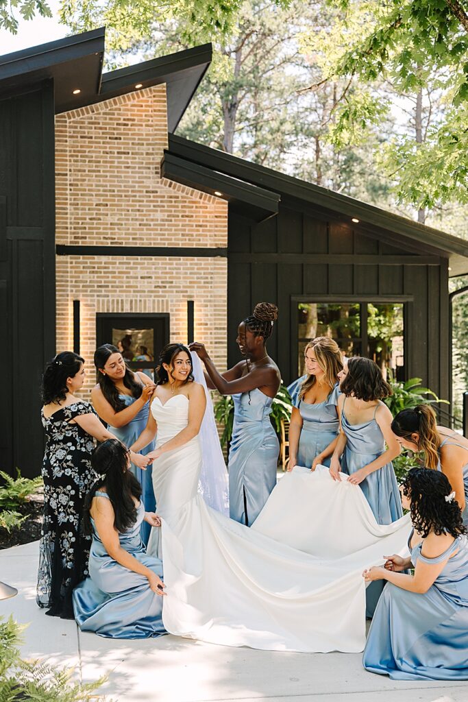 bride and bridesmaids outside of the bridal house at the glass house at Nichols Heir helping bride get ready along with mom of bride