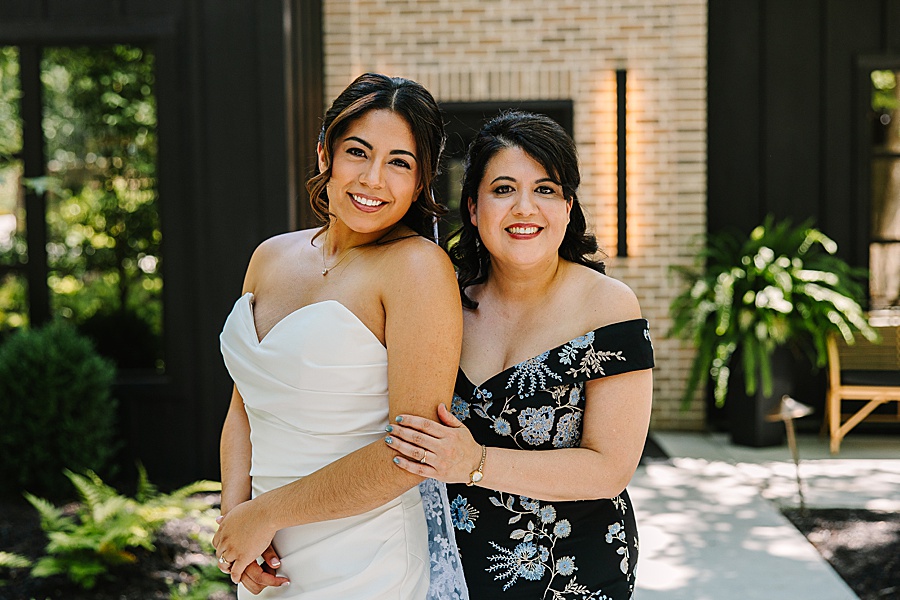 bride and mother embracing outside of bridal house at Nichols Heir