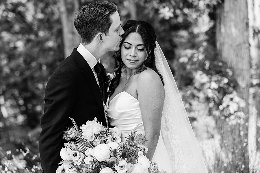 black and white images of bride and groom kissing with bouquet of lush floral design by Valley Flowers in Chattanooga TN