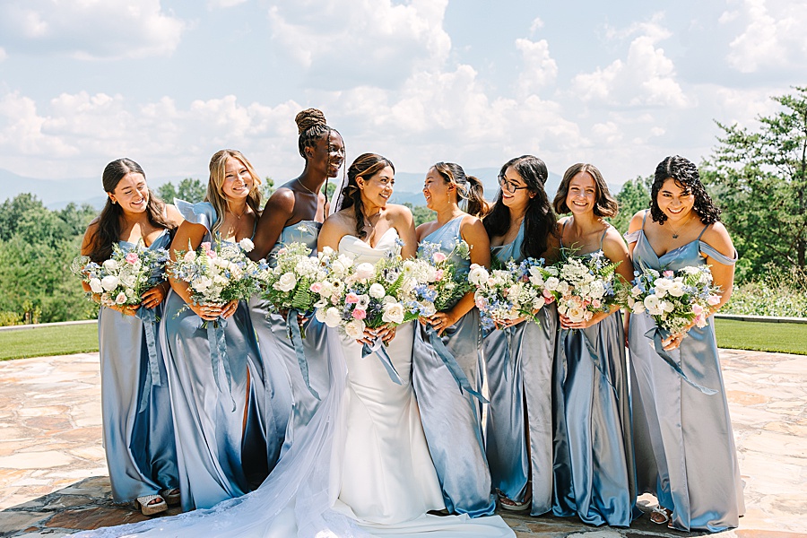 bride and bridesmaids in blue satin dresses and lush floral bouquets designed by Valley Flowers in Chattanooga
