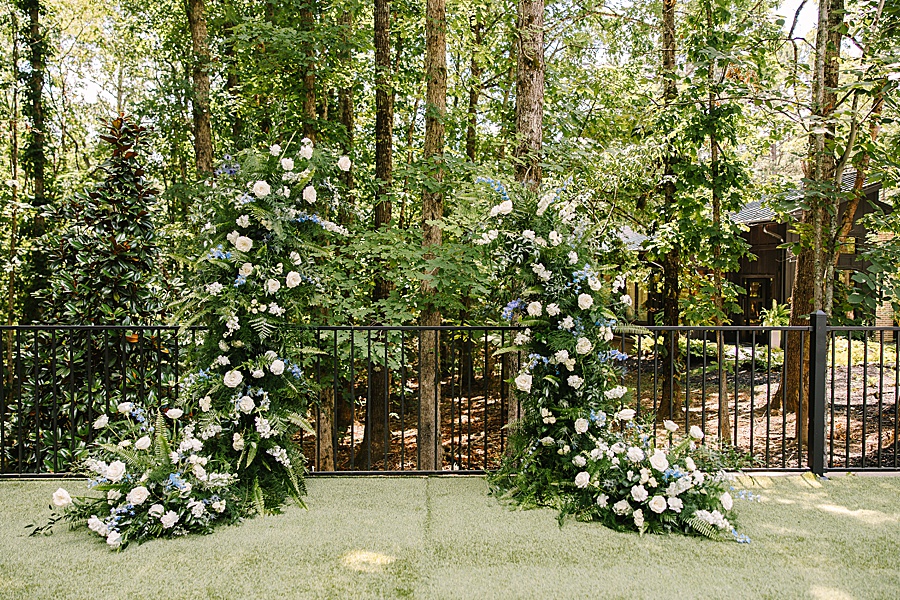 lush floral arch at ceremony site at the glass house at Nichols Heir