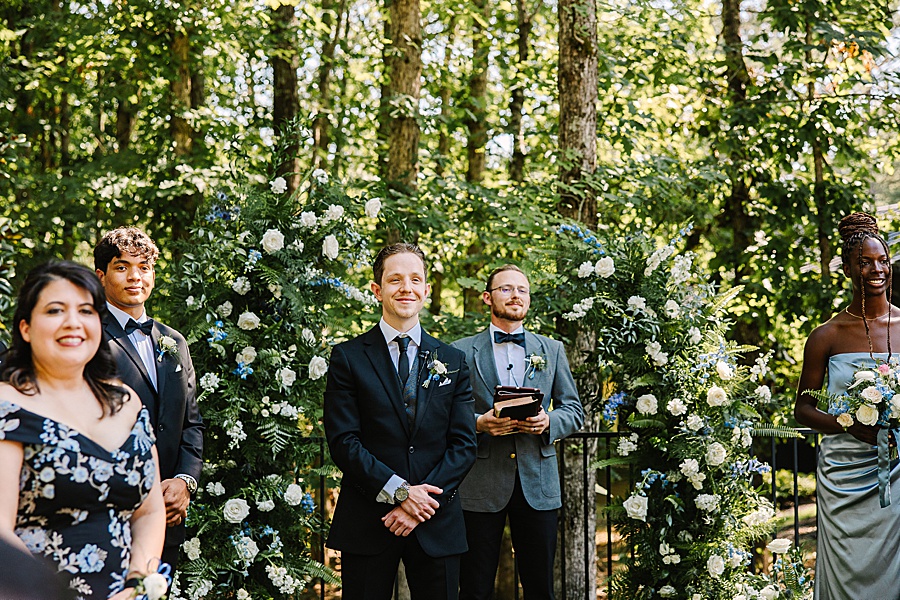 groom waiting for Bride at alter at the garden ceremony site at the glass house