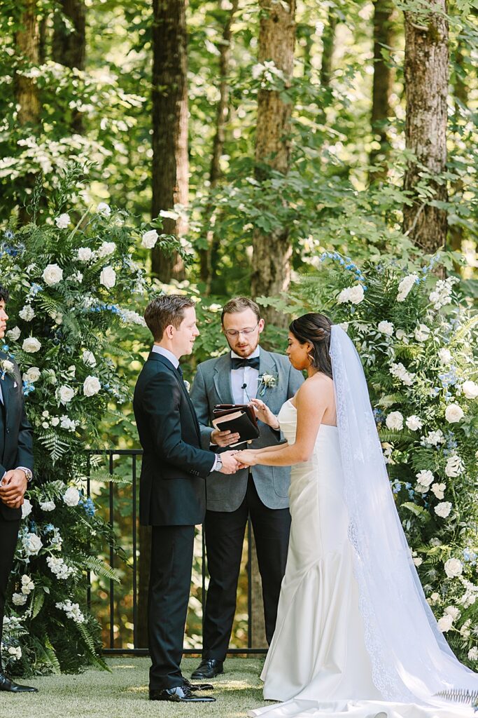 bride and groom during ceremony at the garden ceremony site at glass house at Nichols Heir