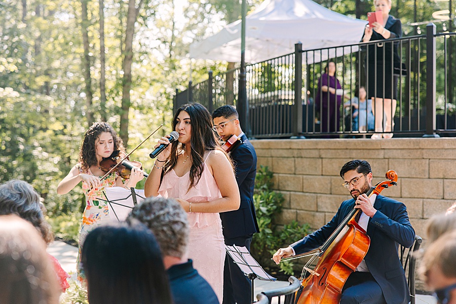 string ensemble and singer at ceremony at glass house at Nichols Heir