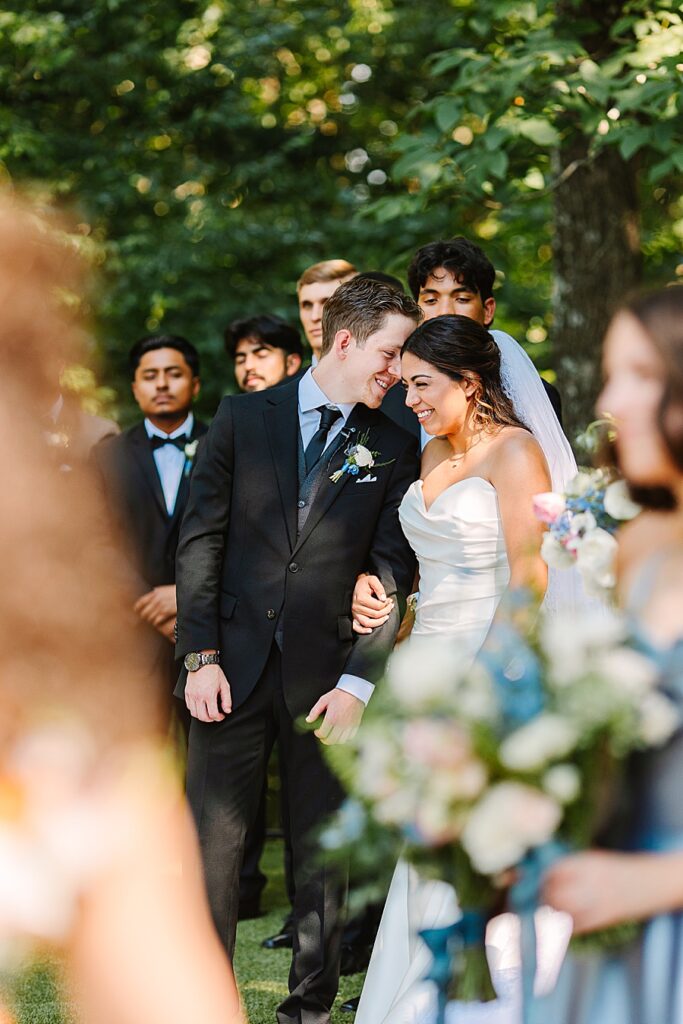 bride and groom laughing with each other during ceremony